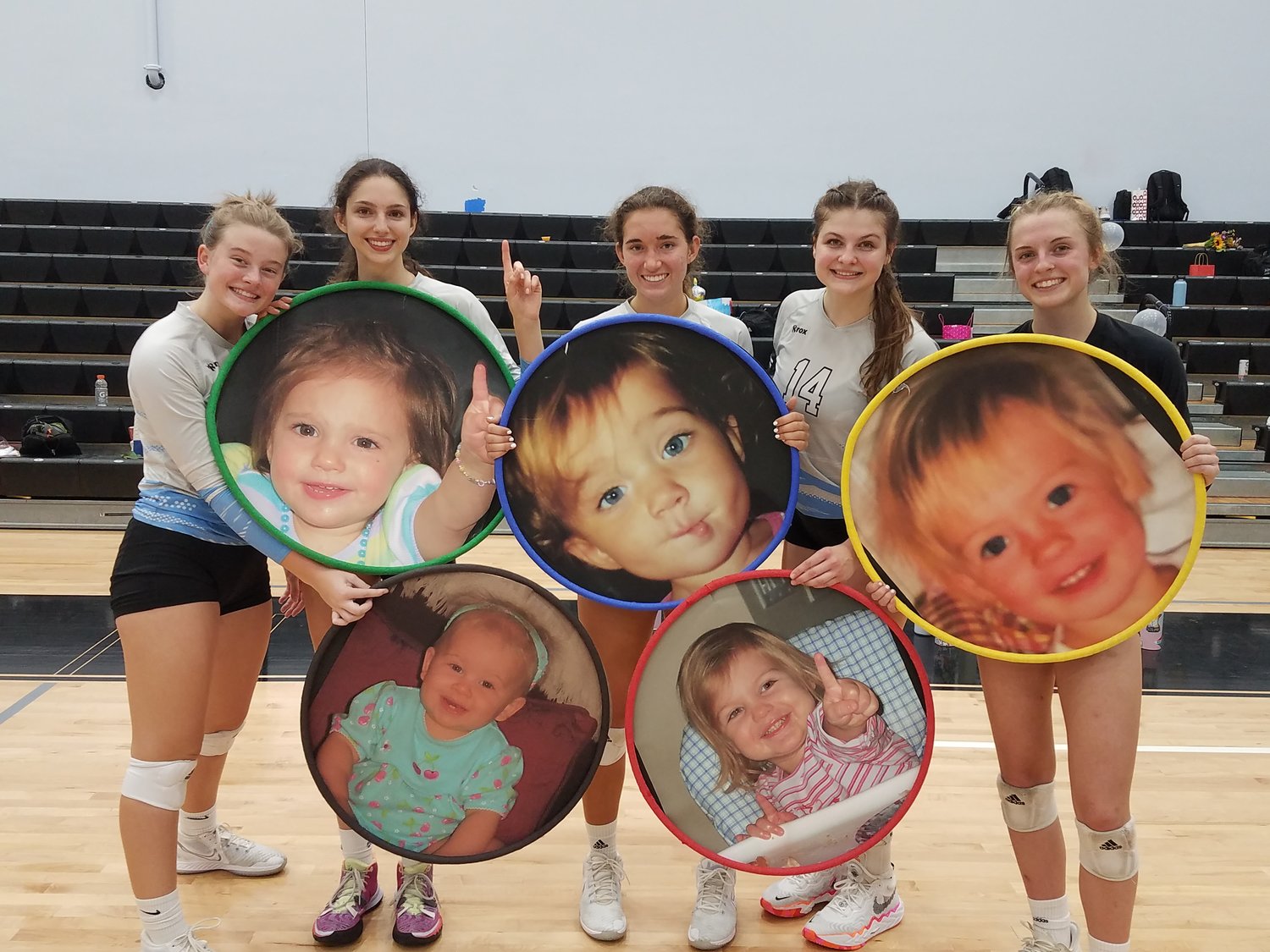 Ponte Vedra senior volleyball players Reed Mann, Jackie Jewett, Kendall Mignerey, Rachel Johnson and Ava Witt hold up baby photos of themselves following a three-set sweep of Bishop Kenny on senior night Friday, Oct. 15.